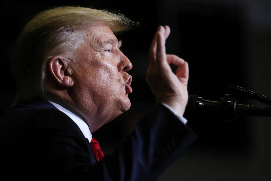 U.S. President Donald Trump reacts during a campaign rally in Tupelo