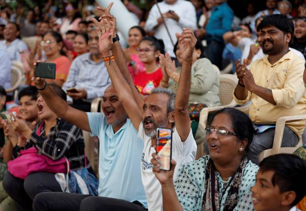People react as they watch a live stream of Chandrayaan-3 spacecraft's landing on the moon, in Ahmedabad