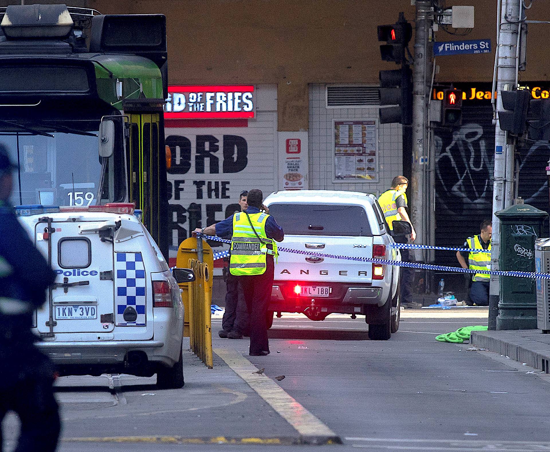 Australian police are seen where a driver was arrested after ploughing into pedestrians at a crowded intersection near the Flinders Street train station in Melbourne