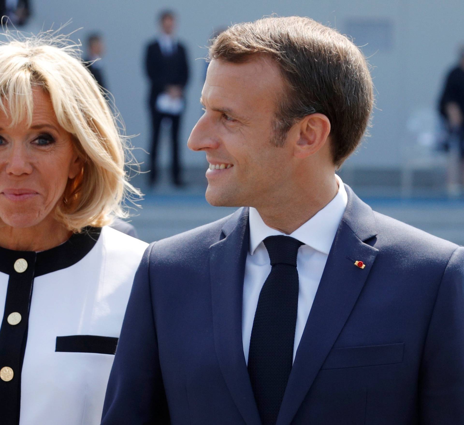 French President Emmanuel Macron and his wife Brigitte Macron leave after the traditional Bastille Day military parade on the Champs-Elysees avenue in Paris