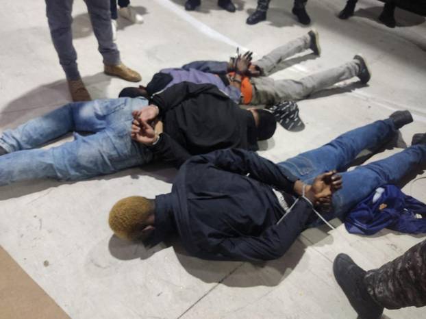 People accused of invading and taking over television station TC with weapons and forcing staff to lie and sit down, lie handcuffed on the floor in a police haundout