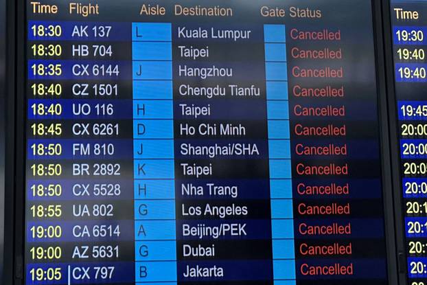 FILE PHOTO: A departure board displays flight cancellations at Hong Kong International Airport, as Super Typhoon Ragasa disrupts travel