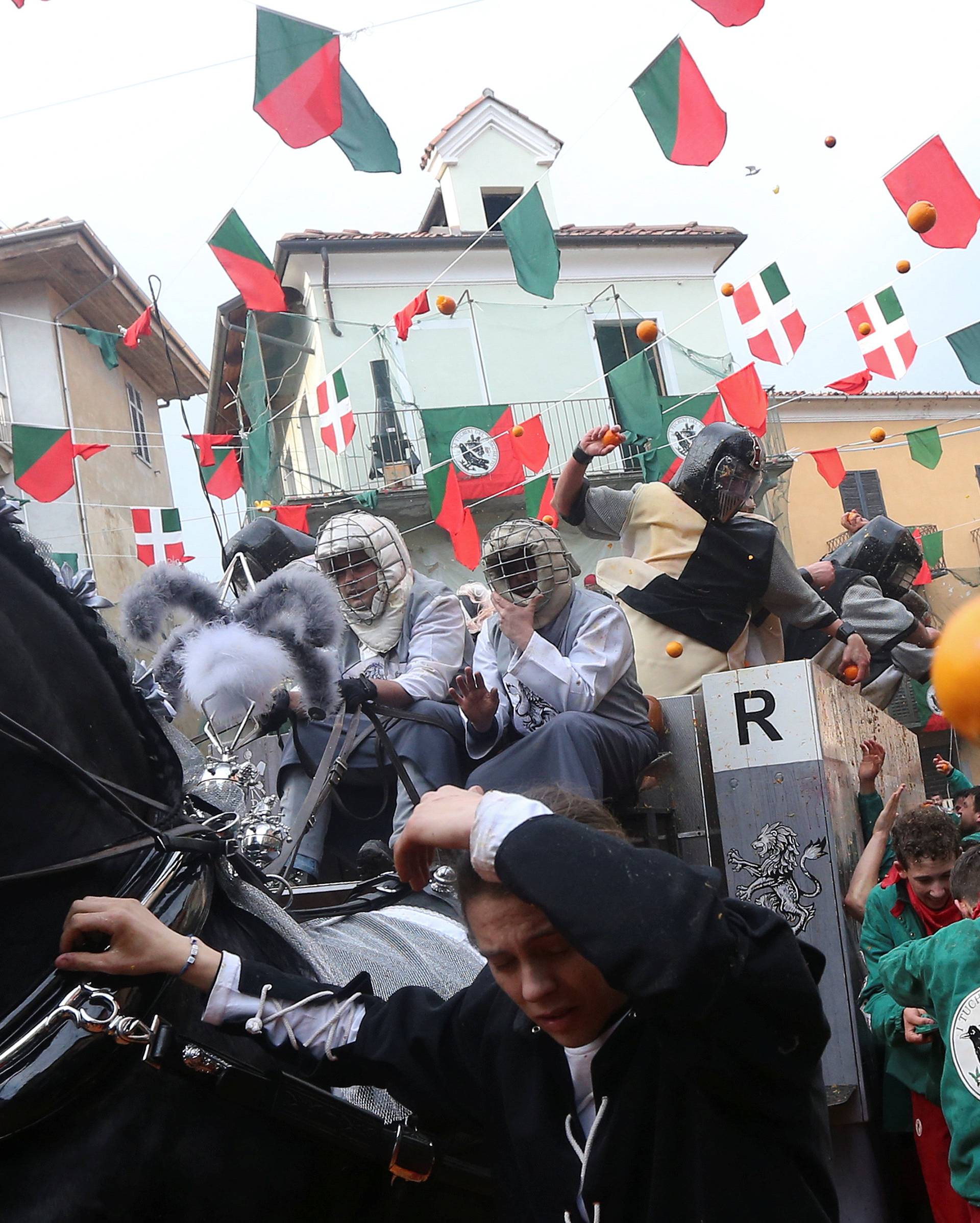 Members of rival teams fight with oranges during an annual carnival battle in the northern Italian town of Ivrea