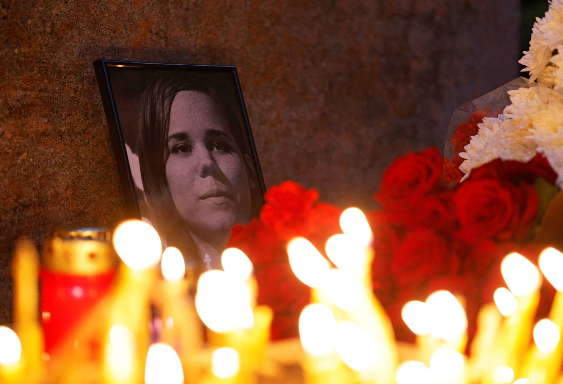 Flowers and candles are placed next to a portrait of Darya Dugina in Moscow