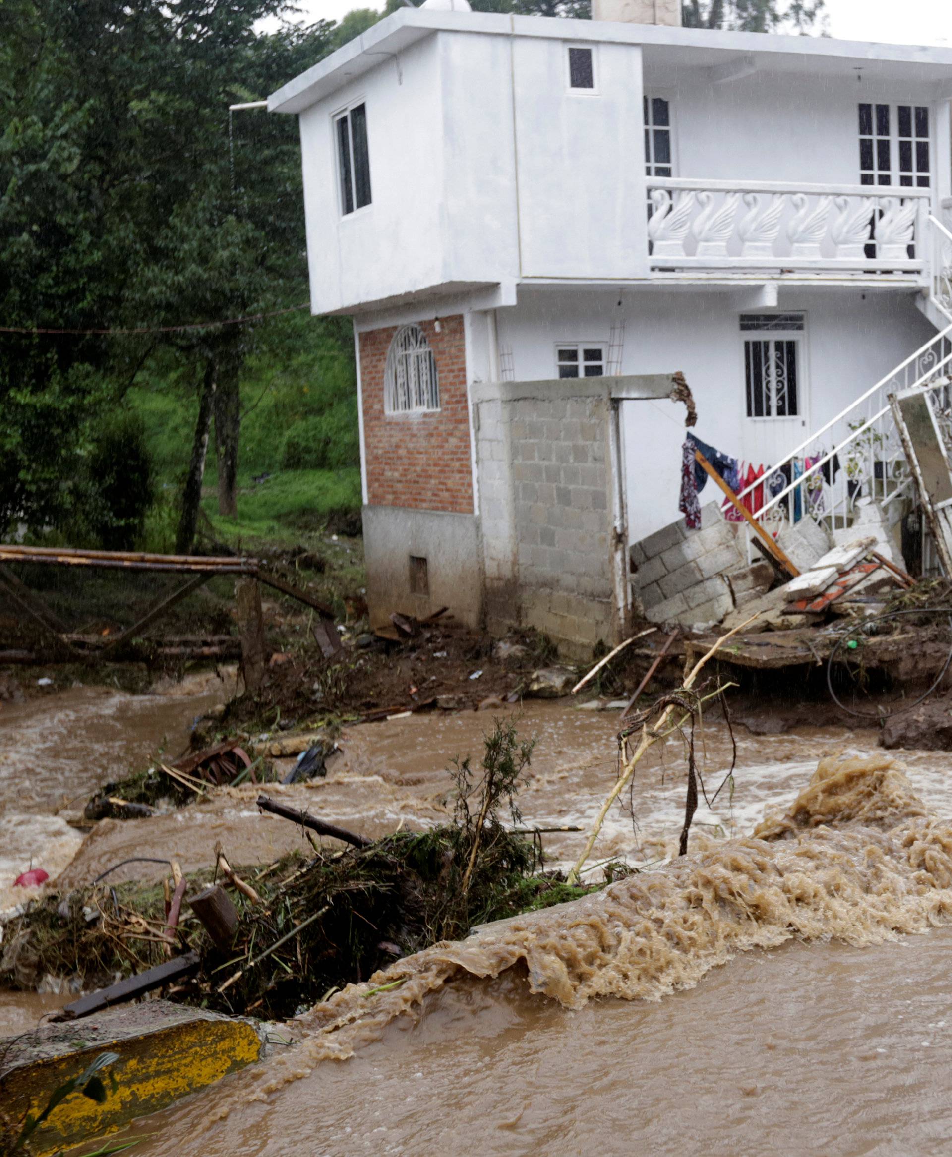 A house damaged after a river overflowed its banks following heavy showers caused by the passing of Tropical Storm Earl, in the town of Huauchinango