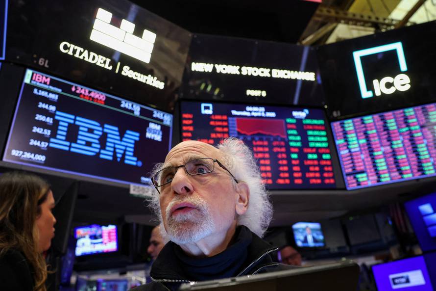 Traders work on the floor of the NYSE in New York