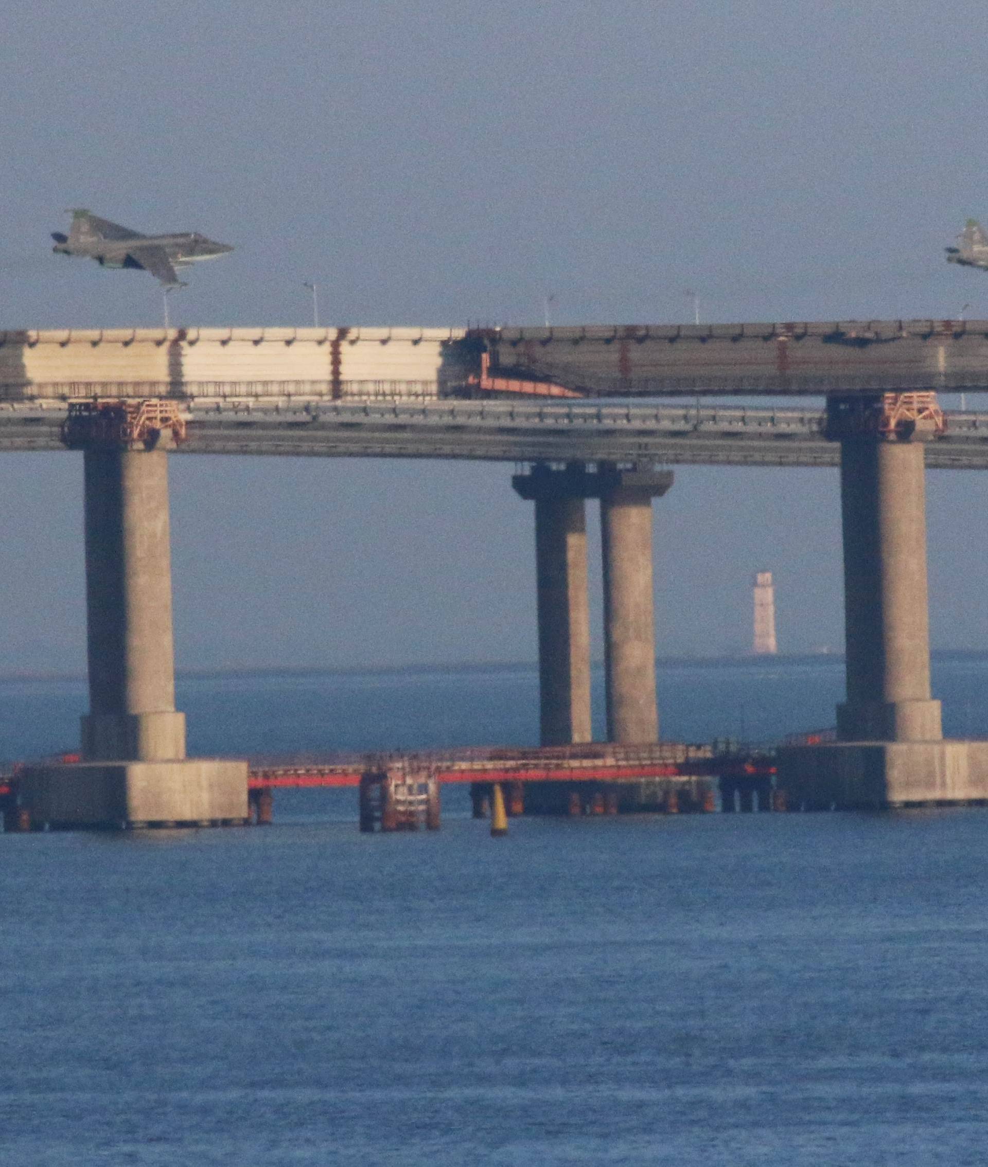 Russian jet fighters fly over a bridge connecting the Russian mainland with the Crimean Peninsula after three Ukrainian navy vessels were stopped by Russia from entering the Sea of Azov via the Kerch Strait in the Black Sea