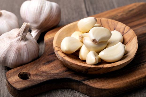 Garlic,Cloves,And,Bulb,In,Vintage,Wooden,Bowl