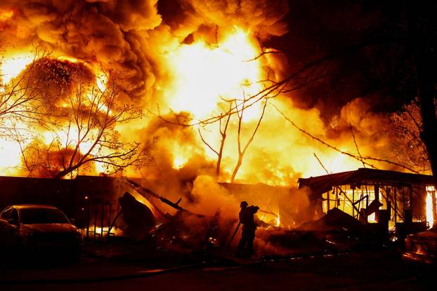 Rescuers work at the site of a Russian missile strike, amid Russia's attack on Ukraine, in Kyiv