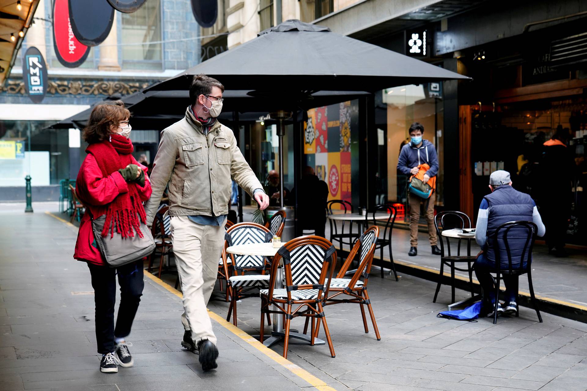 FILE PHOTO: People walk past a cafe after the coronavirus disease (COVID-19) restrictions were eased for the state of Victoria, in Melbourne