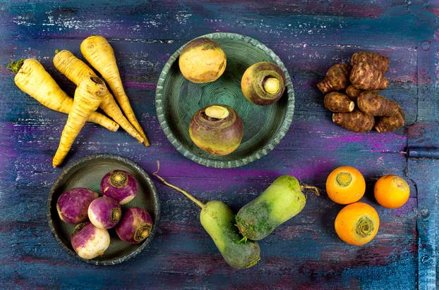 Fresh colorful radish turnip rutabagas roots at farmers market, heirloom varietal vegetables
