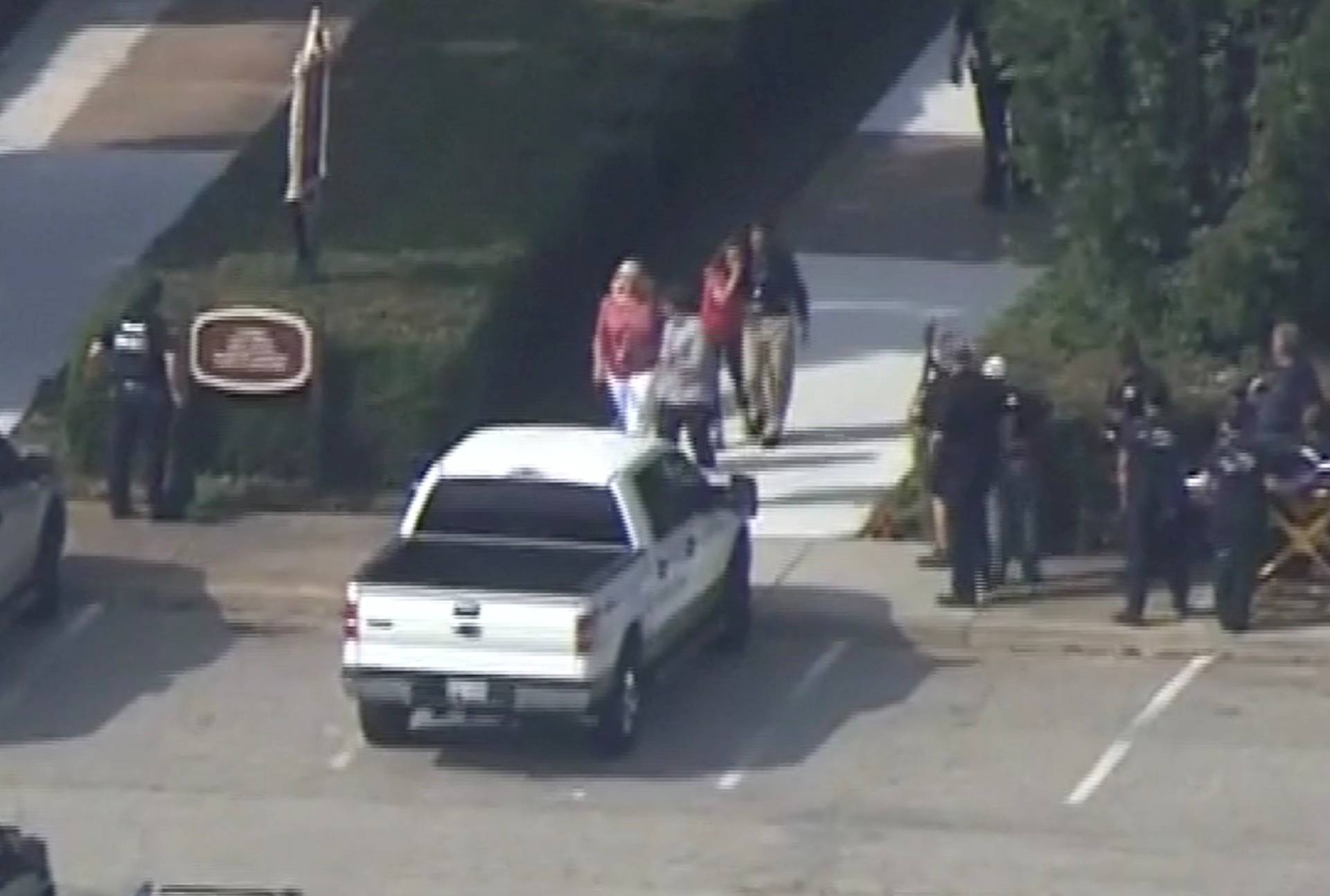 Police evacuate people from a building as a stretcher stands by in this still image taken from video following a shooting incident at the municipal center in Virginia Beach