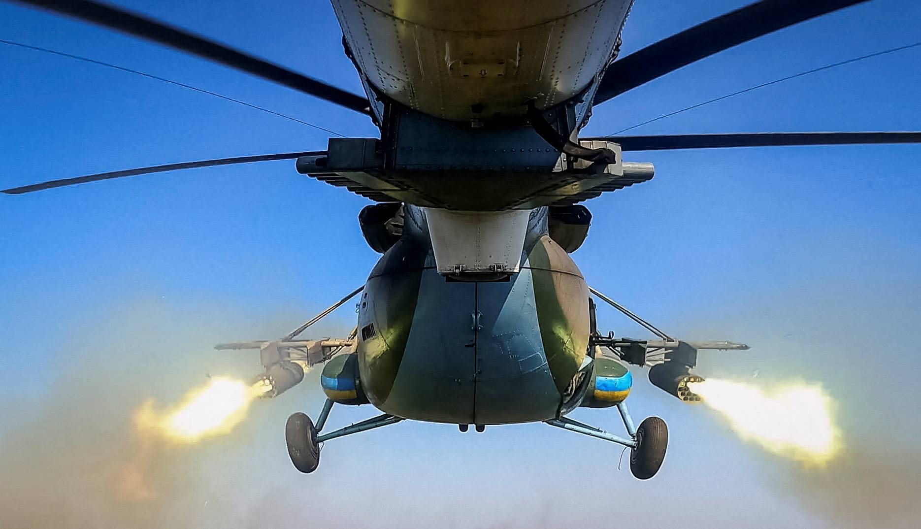 A Ukrainian military Mi-8 helicopter fires unguided missiles towards Russian troops in an undisclosed location in Eastern Ukraine