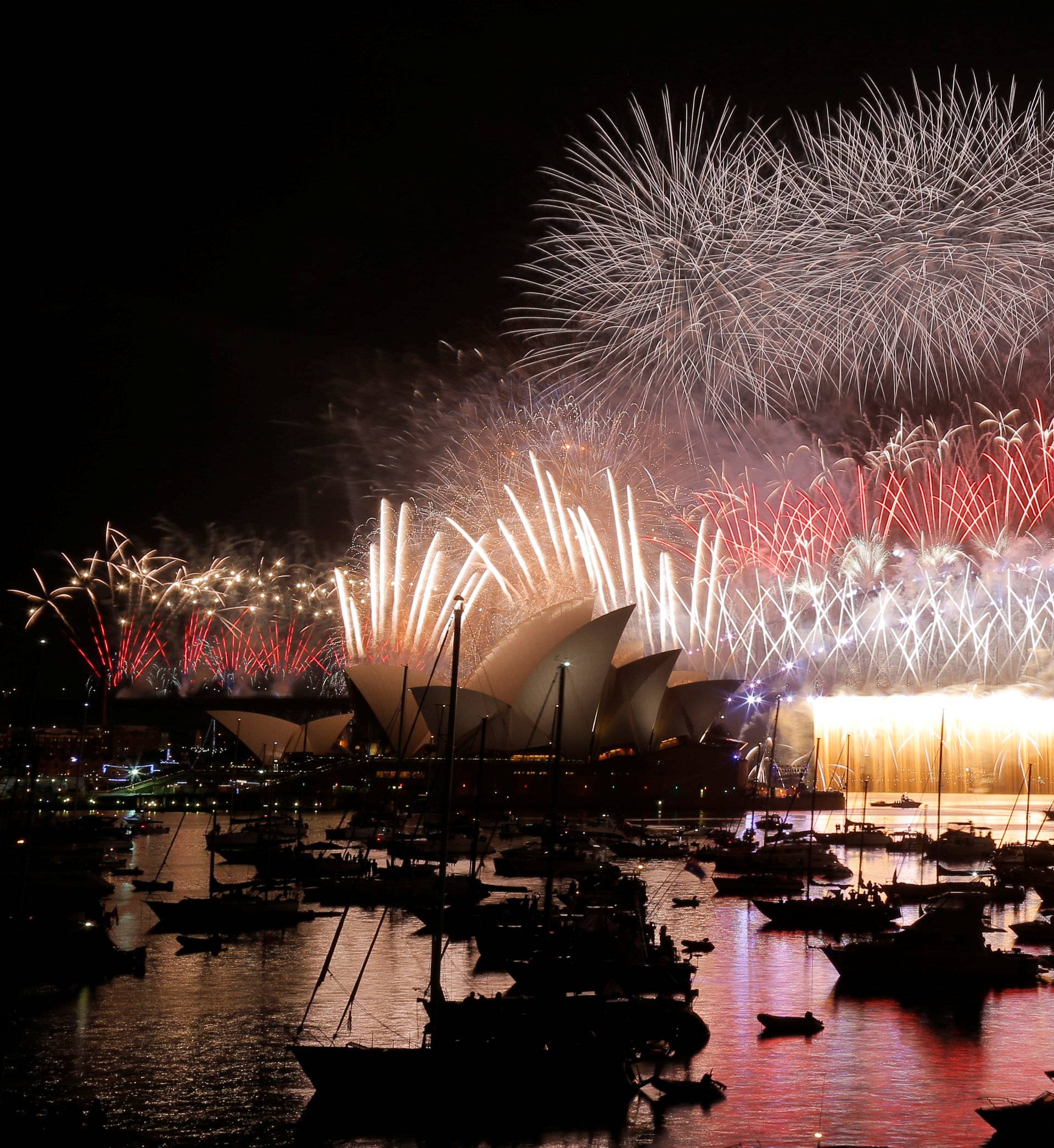 Fireworks explode over the Sydney Opera House and Harbour Bridge as Australia ushers in the New Year in Sydney