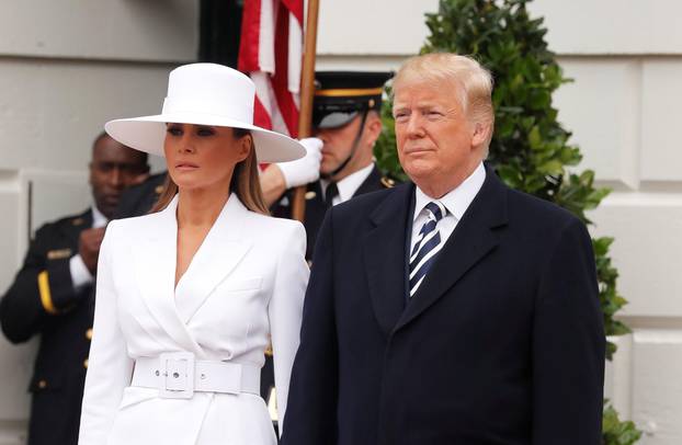 U.S. President Trump and first lady Melania wait to welcome French President Macron and his wife Brigitte during arrival ceremony at the White House in Washington