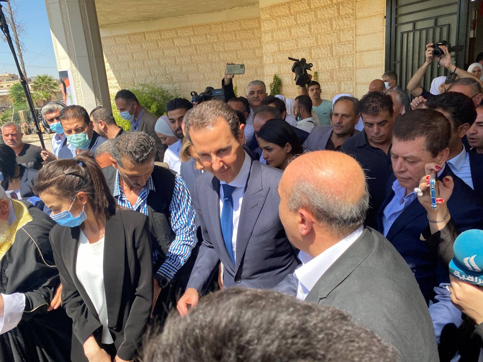 Syria's President Bashar al-Assad leaves a polling station after he casted his vote, during the country's presidential elections in Douma