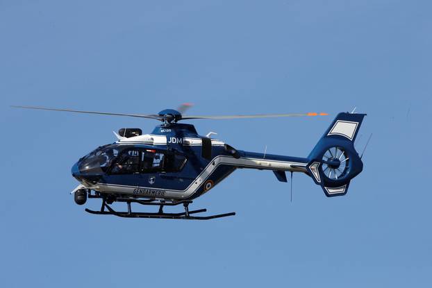 A gendarmerie helicopter flies over the village of Trebes after a hostage situation in a supermarket