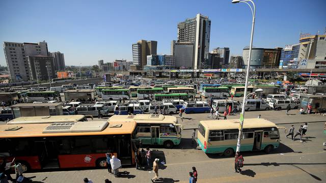 People walk through Megenagna neighbourhood bus station in Addis Ababa