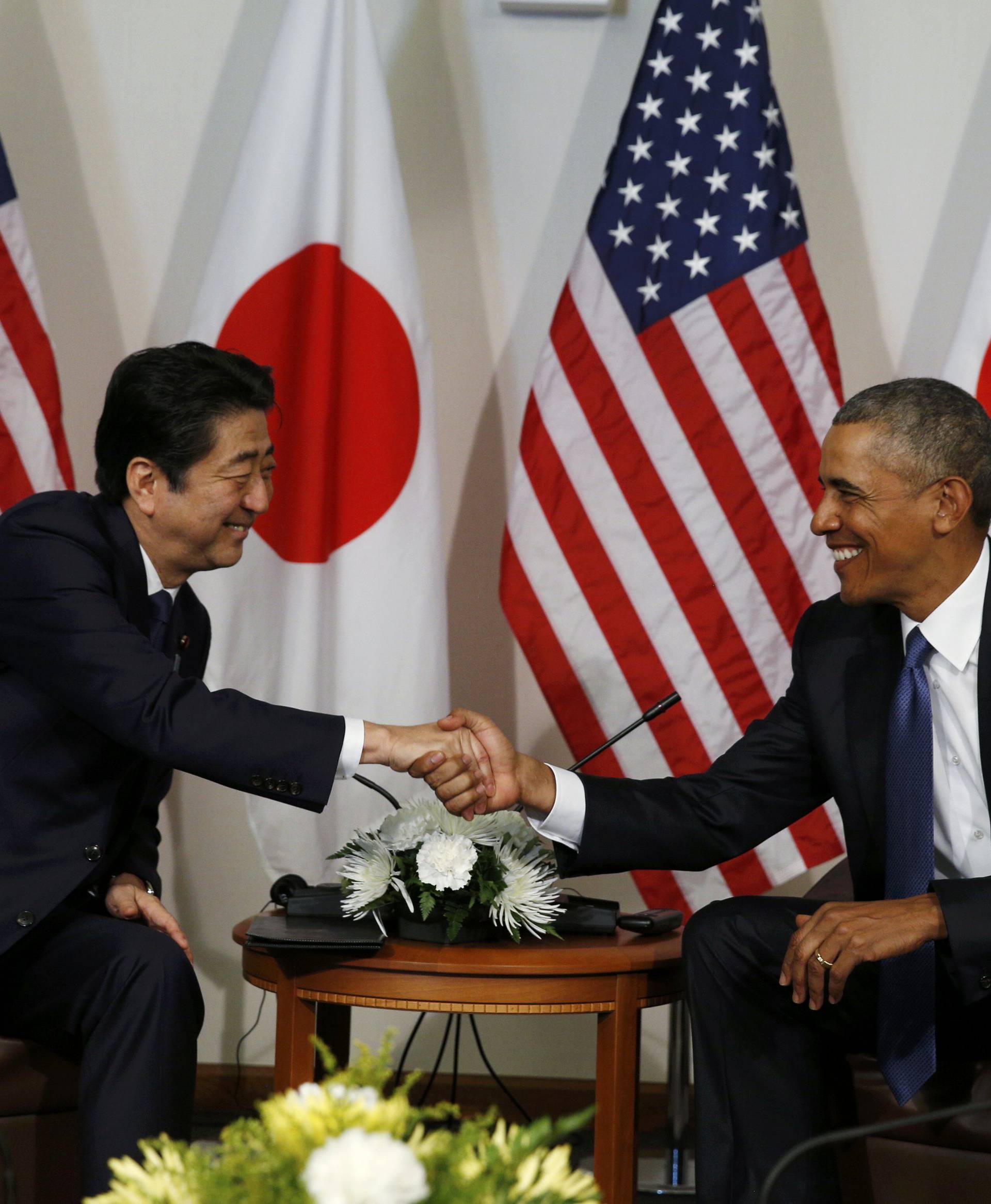 Japanese Prime Minister Abe greets U.S. President Obama at Camp H.M. Smith in Hawaii