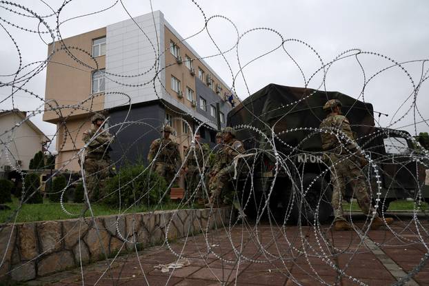 U.S. KFOR soldiers, under NATO, stand guard near a municipal office in Leposavic