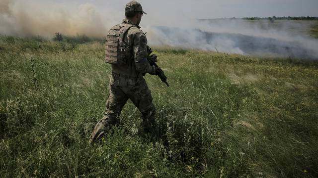 A Ukrainian service member is seen near the front line near the newly liberated village Neskuchne