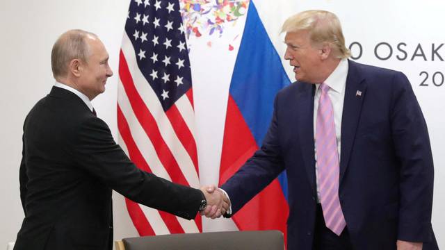 FILE PHOTO: Russia's President Vladimir Putin and U.S. President Donald Trump attend a meeting on the sidelines of the G20 summit in Osaka