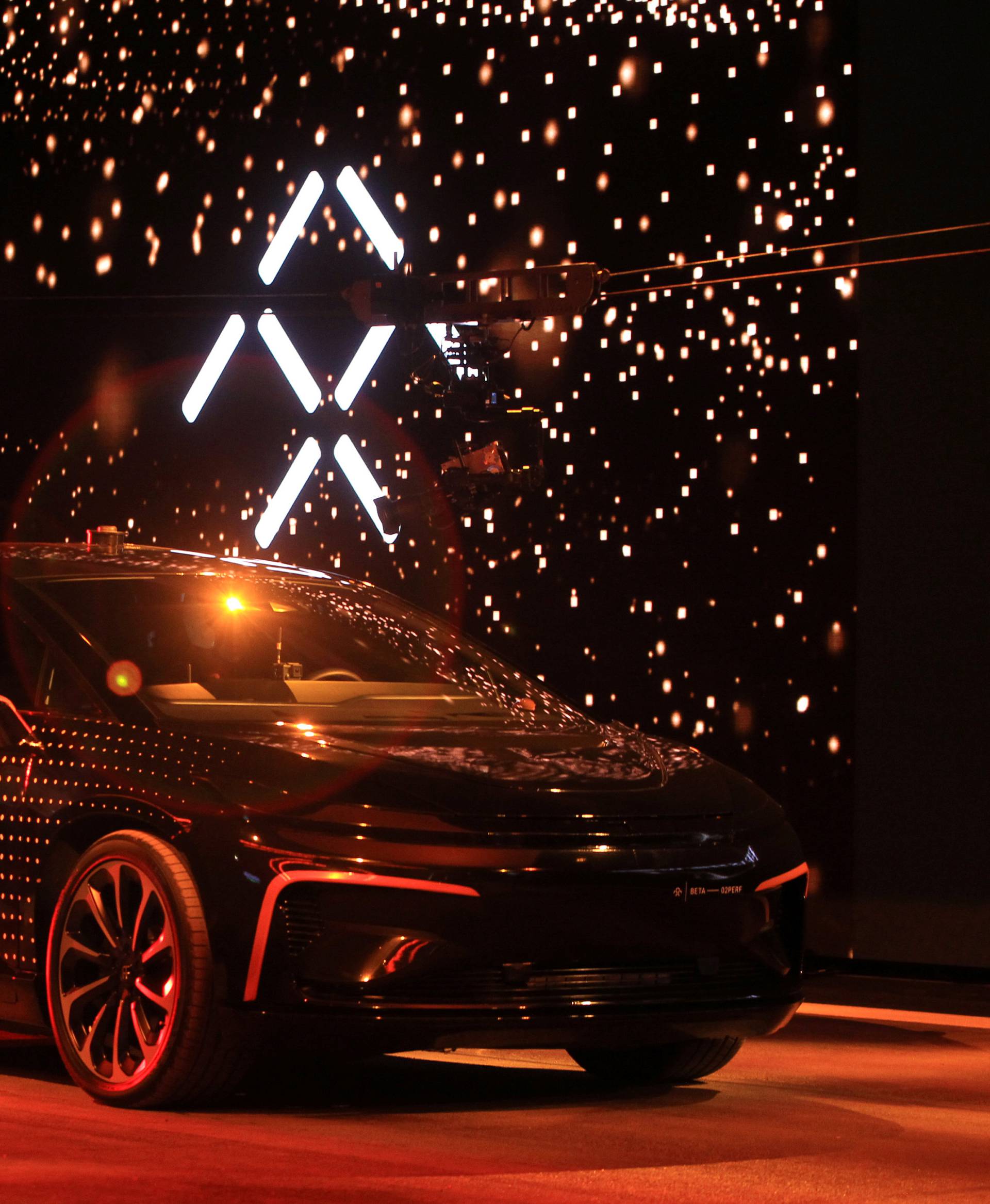 A Faraday Future FF 91 electric car arrives on stage for an exhibition of speed during an unveiling event at CES in Las Vegas
