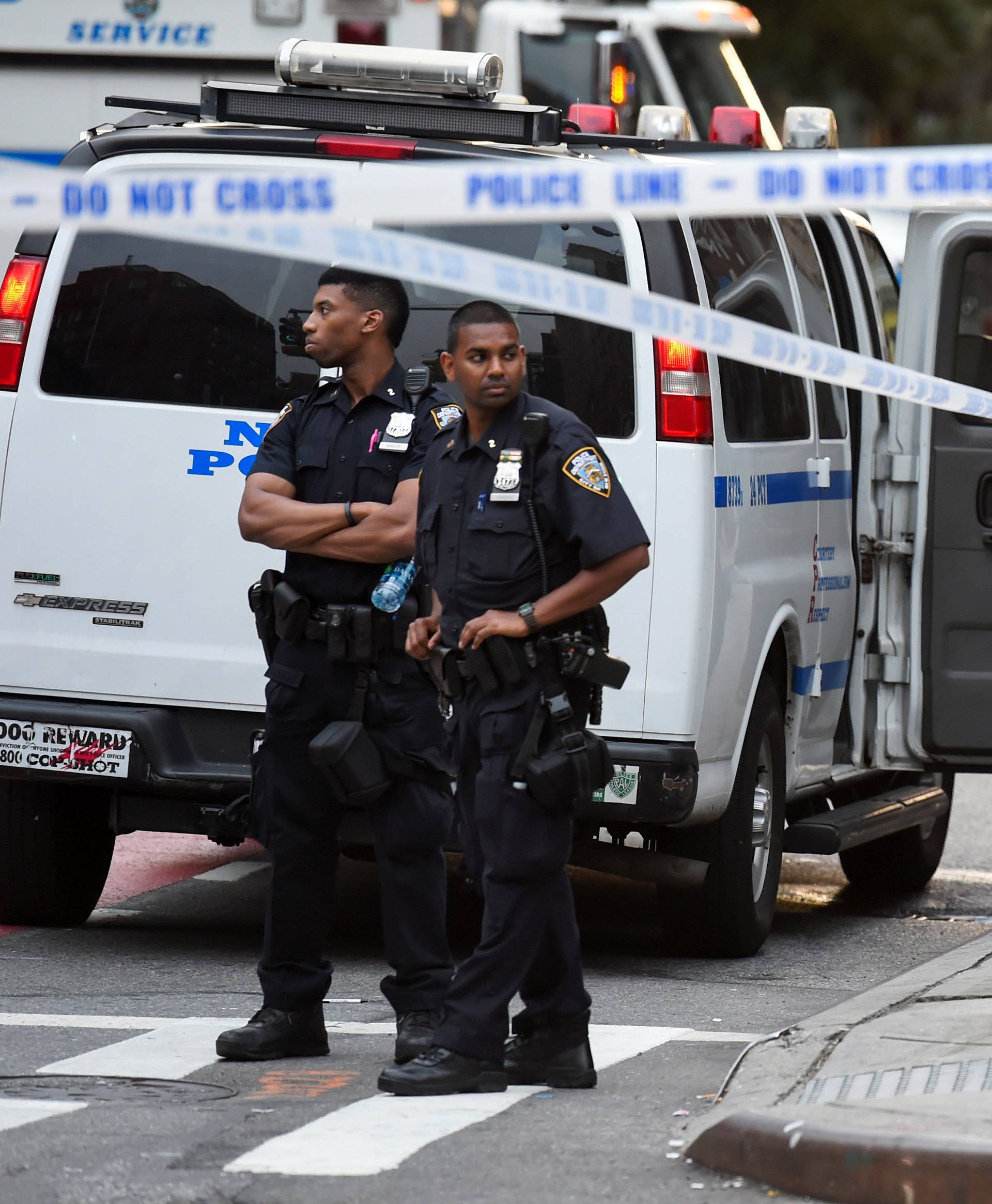 NYPD officers stand near the site of an explosion in New York