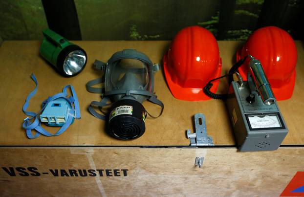 A gas mask, a Geiger counter and emergency goods are seen in Shelter Co.
