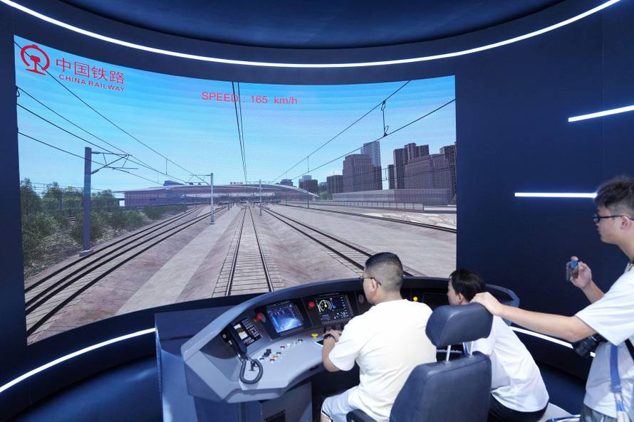 Visitors experience simulator driving of Fuxing bullet trains. Beijing,China.9th July 2025. The 17th China International Modern Railway Technology & Equipment Exhibition, held concurrently with the 12th World Congress on High-Speed Rail, attracted numerou