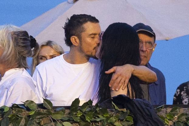 EXCLUSIVE: Katy Perry and Orlando Bloom share a passionate kiss as they attend the star-studded Bruce Springsteen performance at the "American Express presents BST Hyde Park" festival.