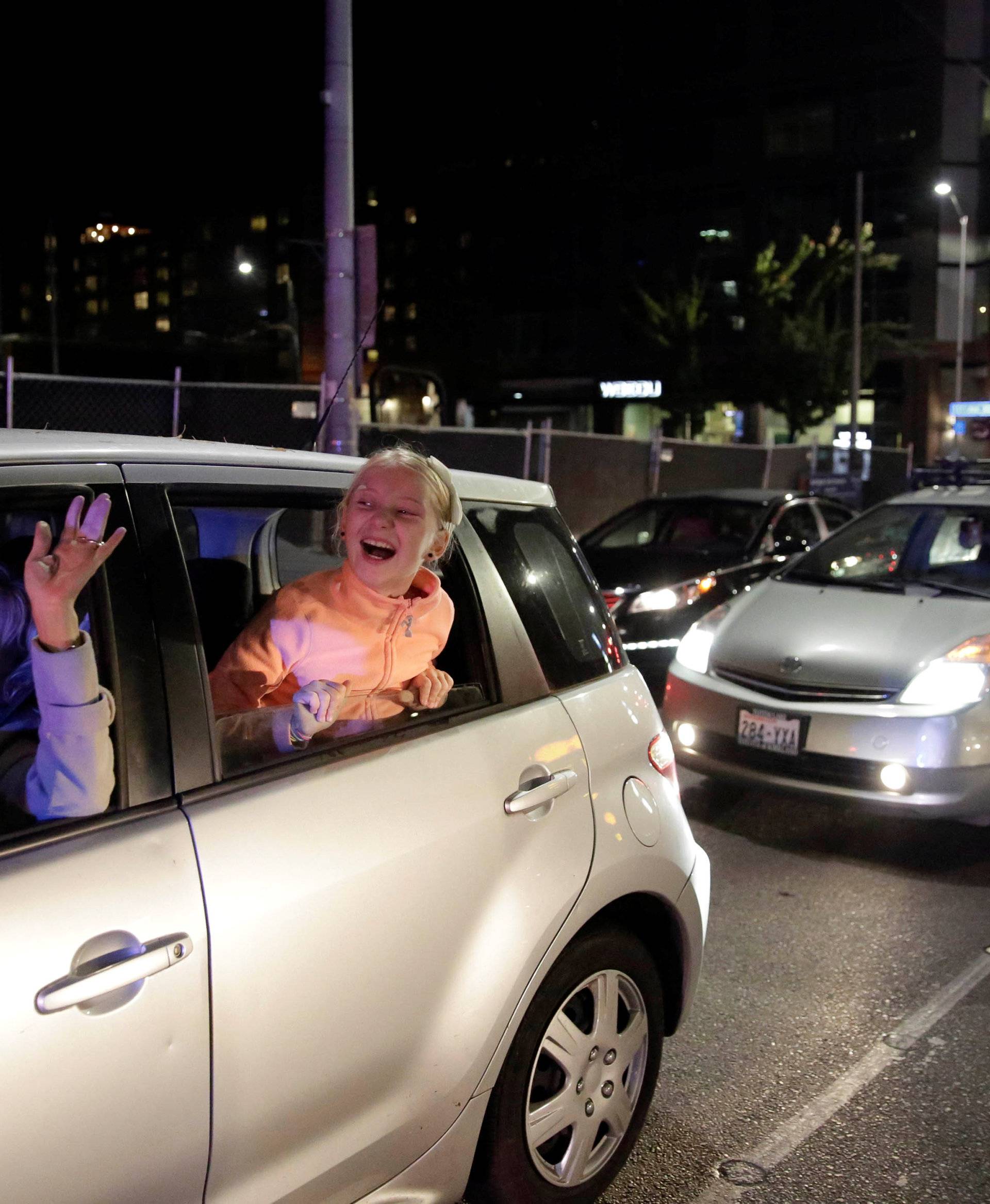 People stuck in traffic react to a protest to the election of Republican Donald Trump as the president of the United States in Seattle, Washington