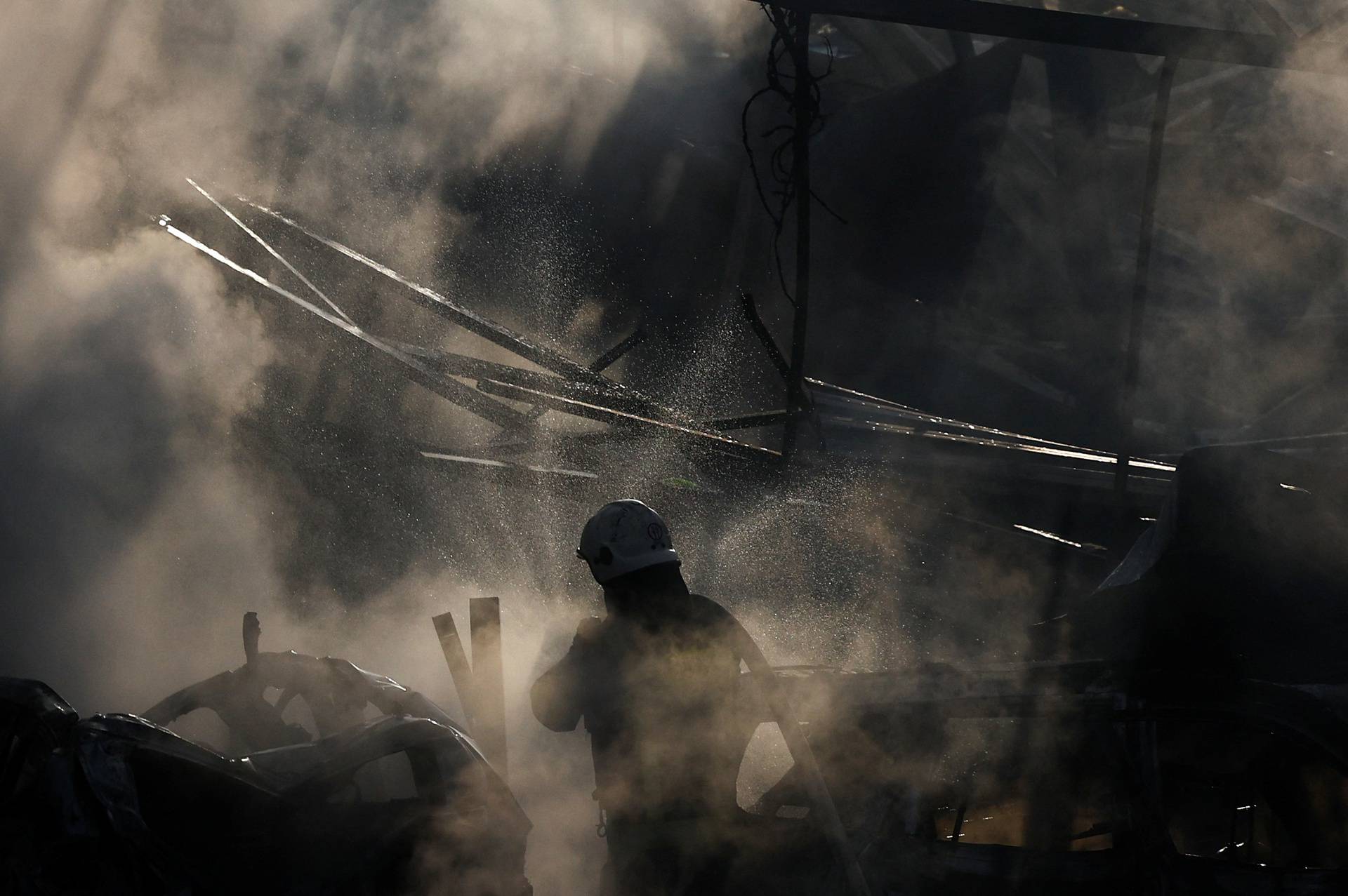 Firefighters work at a site damaged during a Russian missile strike, in Kyiv