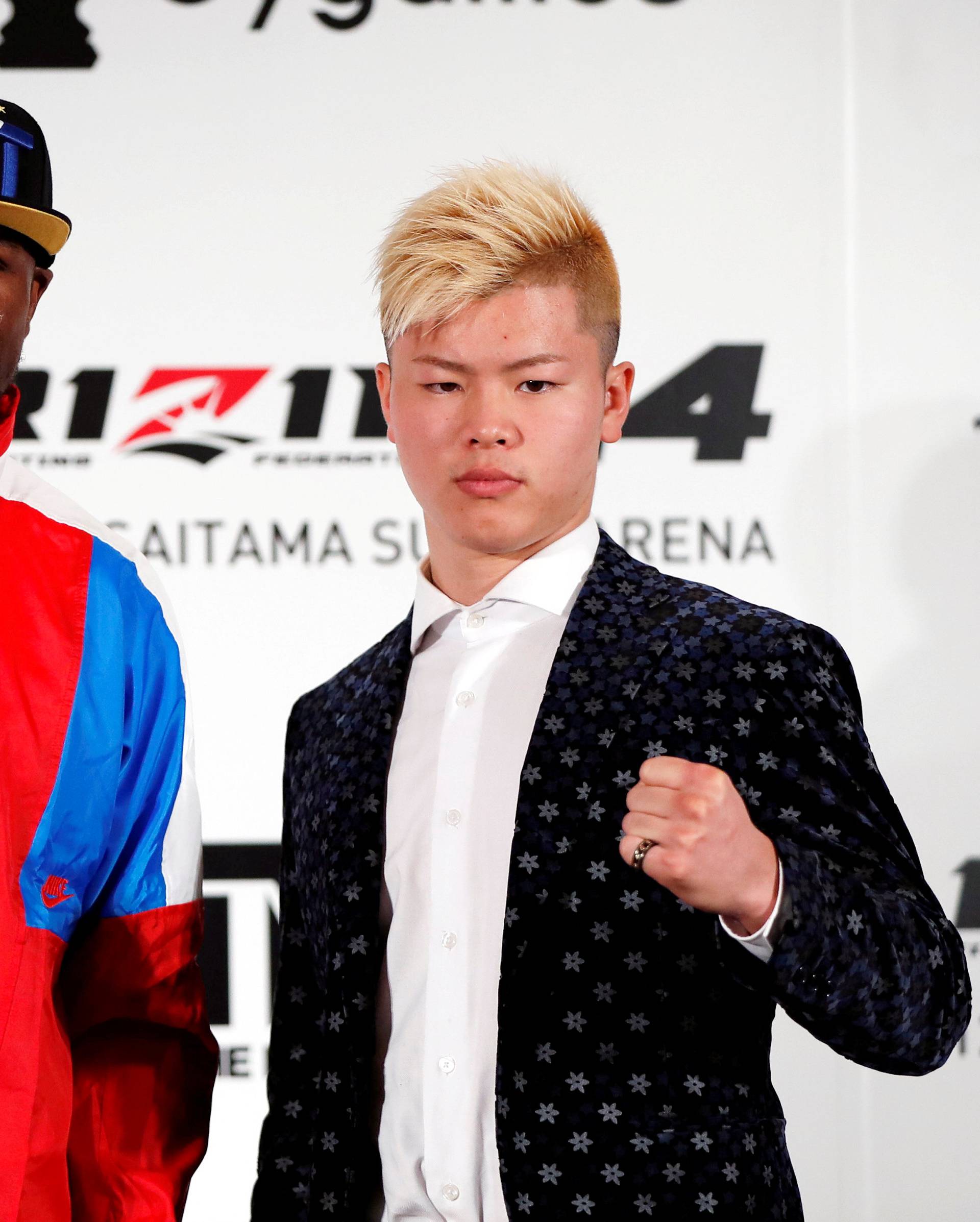 Boxer Floyd Mayweather Jr. of the U.S. poses for a photograph with his opponent Tenshin Nasukawa during a news conference in Tokyo