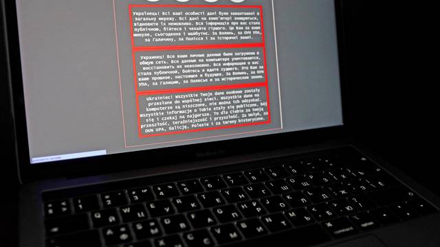 A laptop screen displays a warning message on the official website of the Ukrainian Foreign Ministry, in this illustration