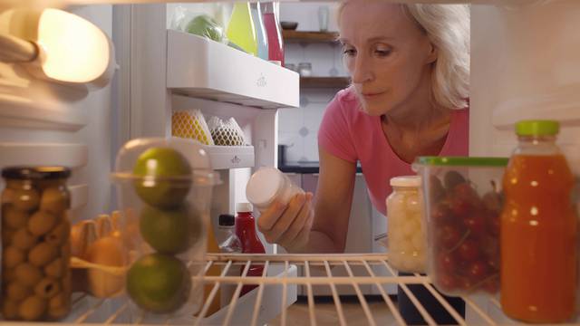 View,From,Inside,Fridge,Of,Senior,Lady,Taking,Bottle,With
