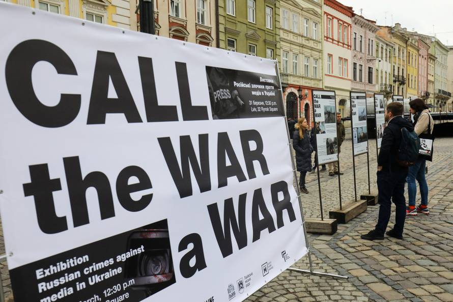 People attend the street event "Call the War a War", in Lviv