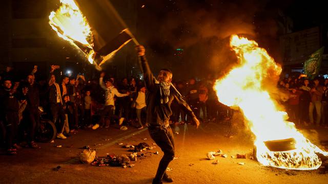 Palestinians celebrate following Jerusalem's shooting attack, in Gaza City