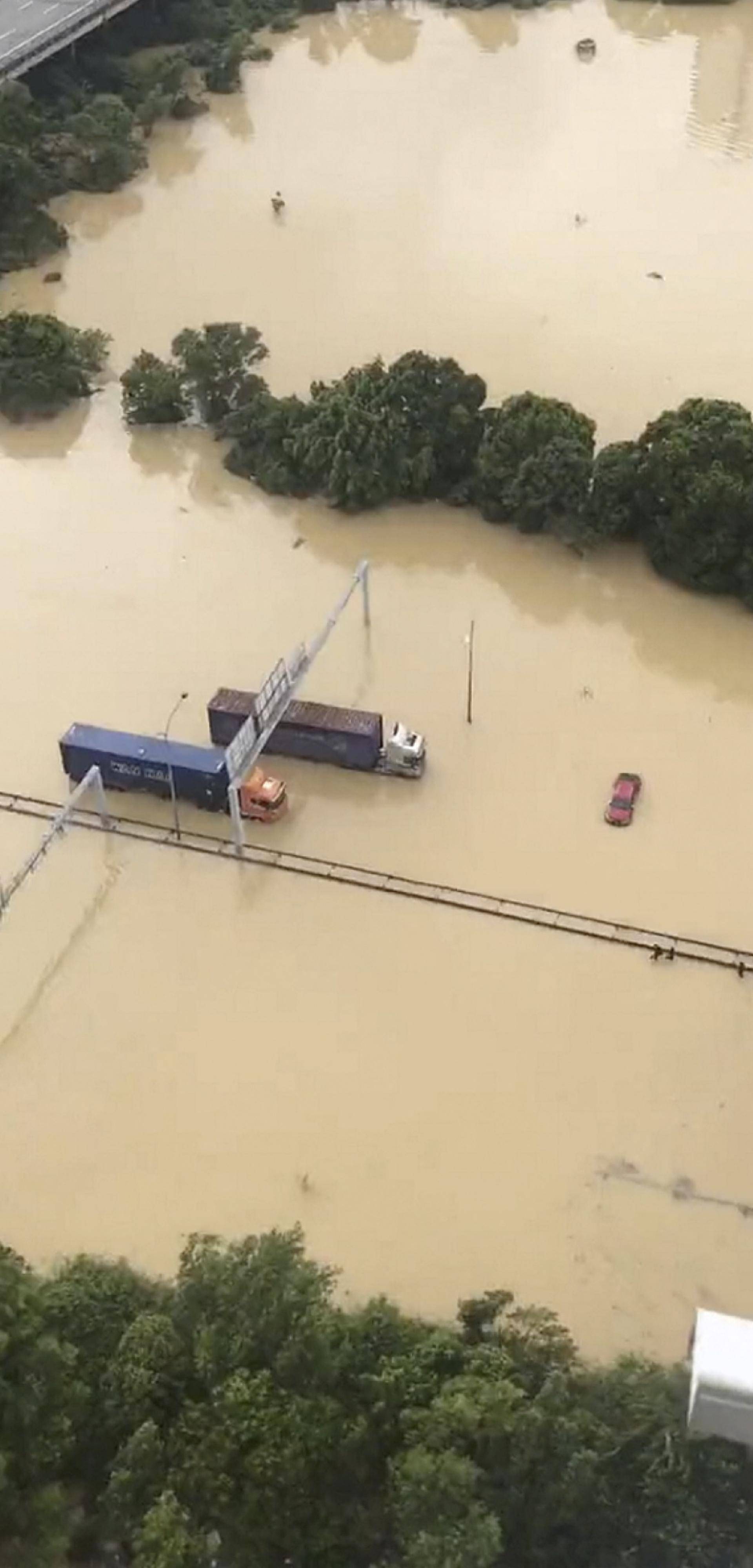 A view shows various vehicles stranded in the middle of flooded road, in Shah Alam