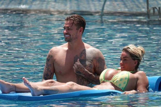 *PREMIUM-EXCLUSIVE* *MUST CALL FOR PRICING* Katie Price AKA Jordan pictured showcasing her bikini body while relaxing by the pool with boyfriend Carl Woods during their holiday in Thailand.