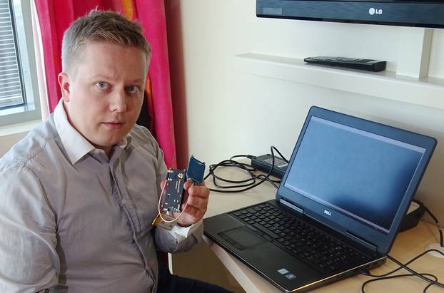 F-Secure researcher Hirvonen shows a device that is able to create a master key out of a single hotel key card in Helsinki