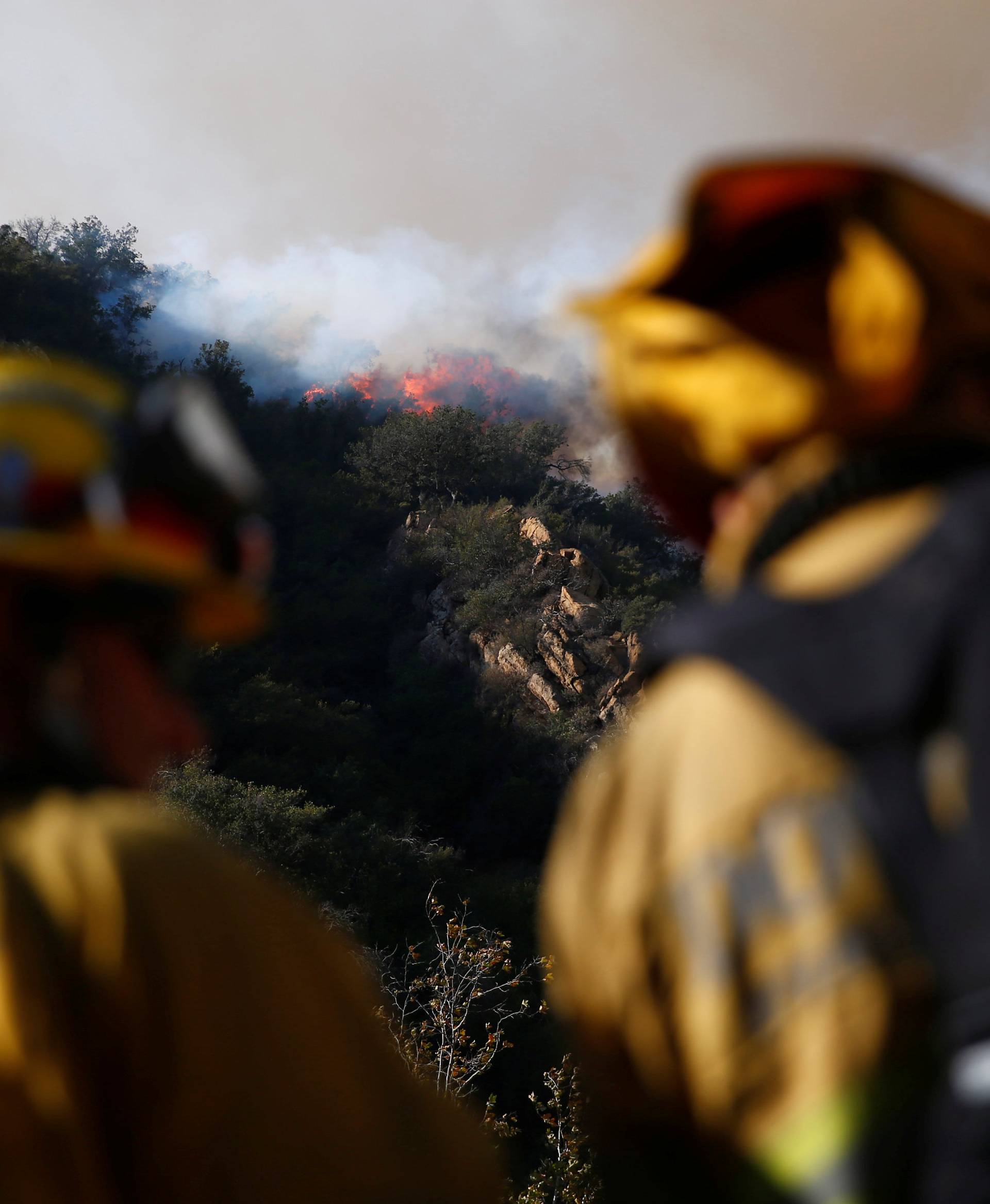 Firefighters battle the Woolsey Fire as it continues to burn in Malibu, California,