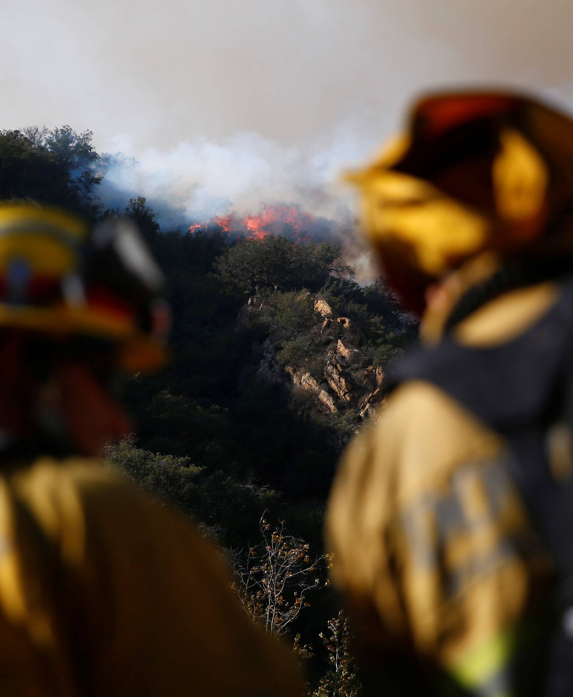 Firefighters battle the Woolsey Fire as it continues to burn in Malibu, California,