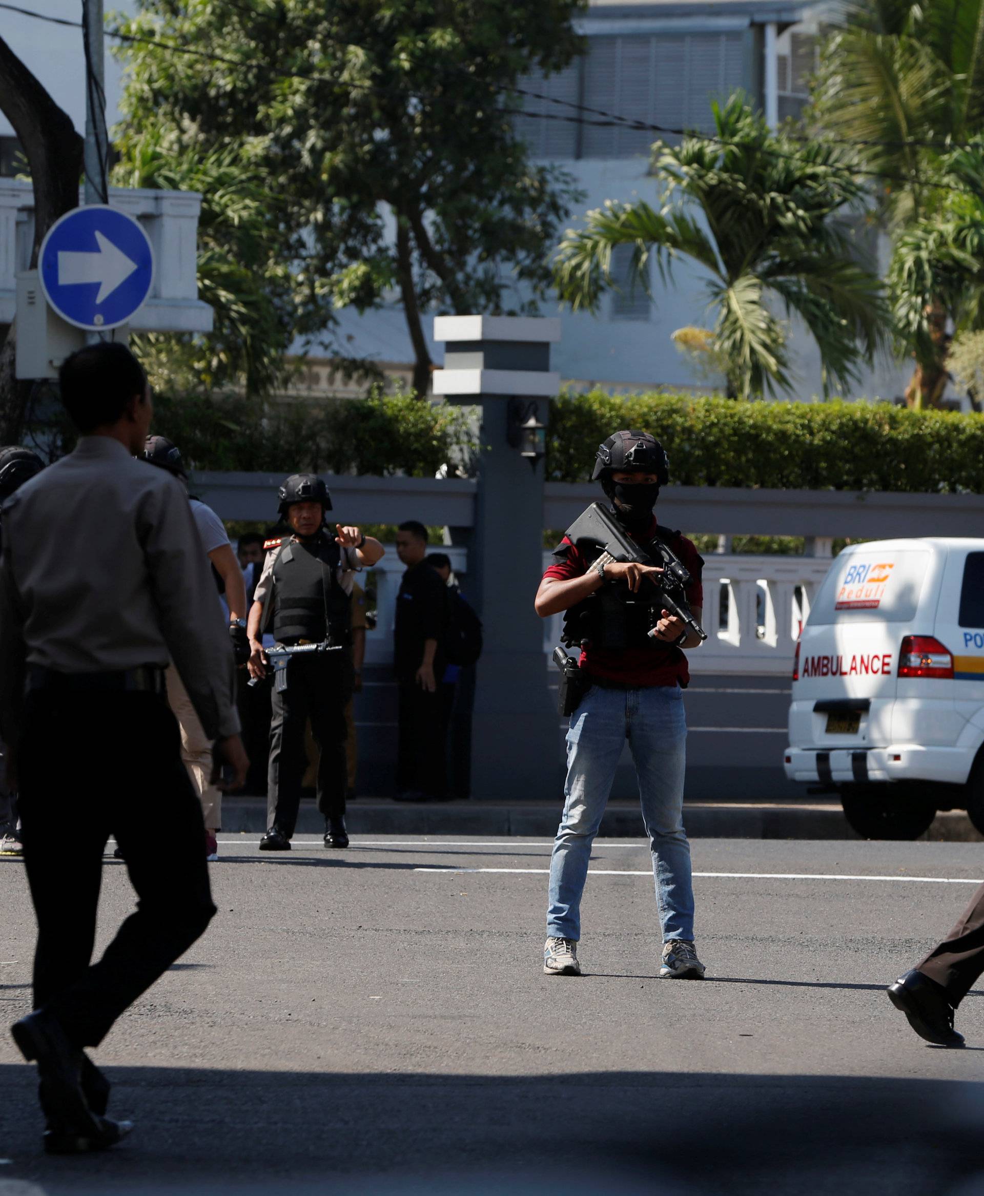 Anti-terror policemen stand guard following a bomb blast in front of a police office in Surabaya