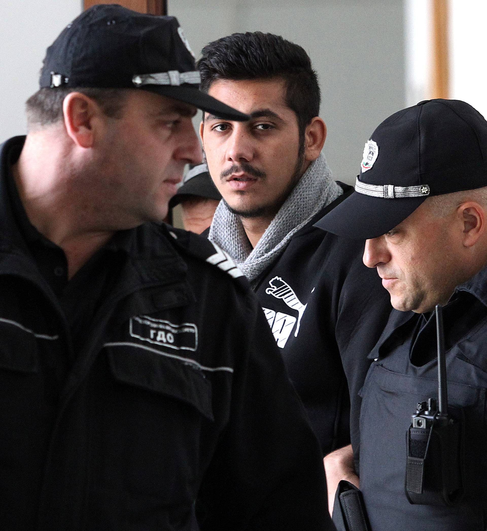 Bulgarian police escort Krasimirov, who was arrested in Germany over the killing of TV journalist Marinova, during his first appearance in court in Ruse