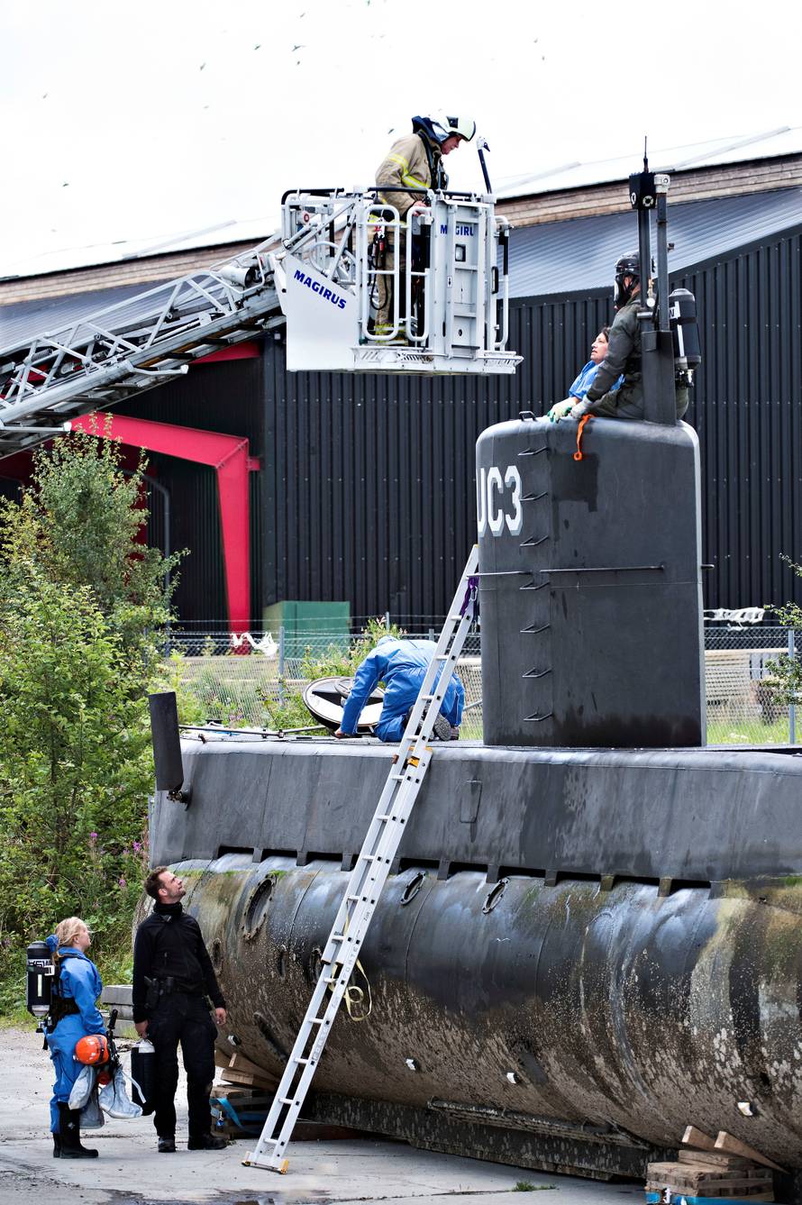 Police technicians investigate the rescued private submarine "UC3 Nautilus" in Copenhagen Harbor