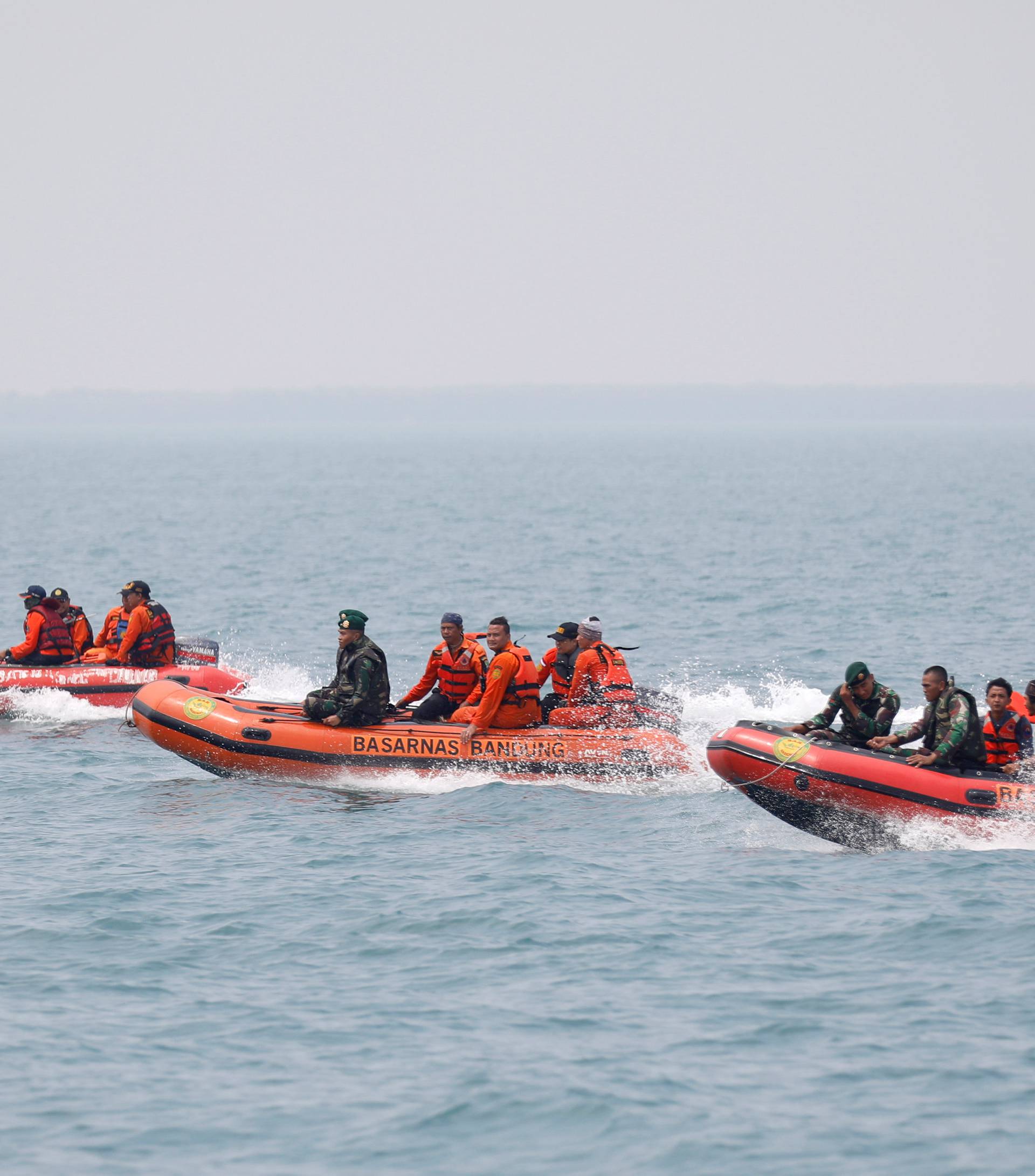 Rescue workers travel to a search area near Tanjung Pakis beach in Karawang, Indonesia