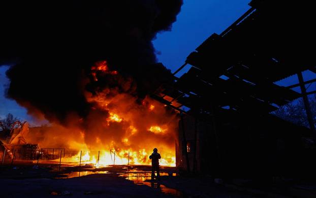 Rescuers work at the site of a Russian missile strike, amid Russia's attack on Ukraine, in Kyiv