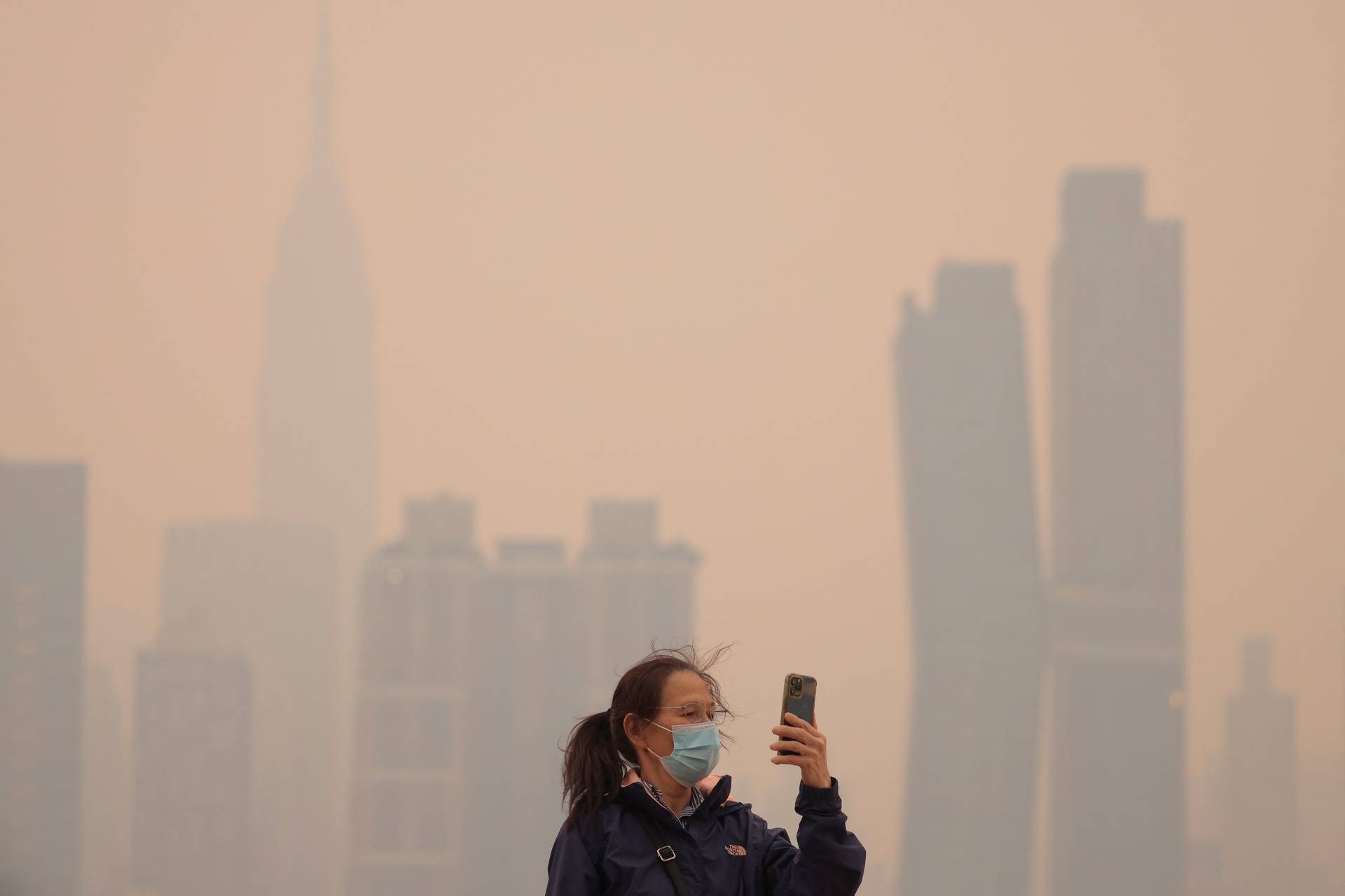 Haze and smoke caused by wildfires in Canada hang over the Manhattan skyline, in New York City