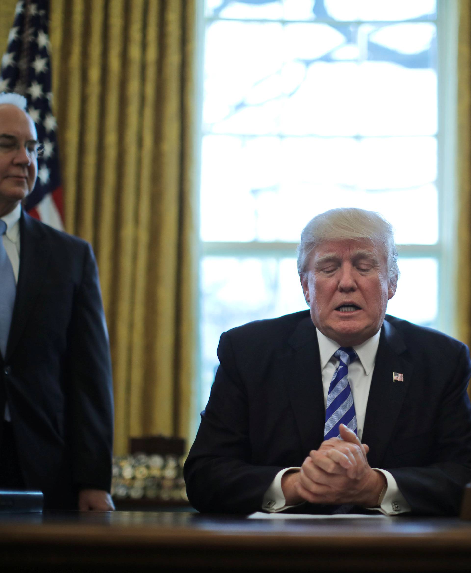 President Trump talks to journalists at the Oval Office of the White House after the AHCA health care bill was pulled before a vote, accompanied by U.S. Health and Human Services Secretary Tom Price and Vice President Mike Pence, in Washington
